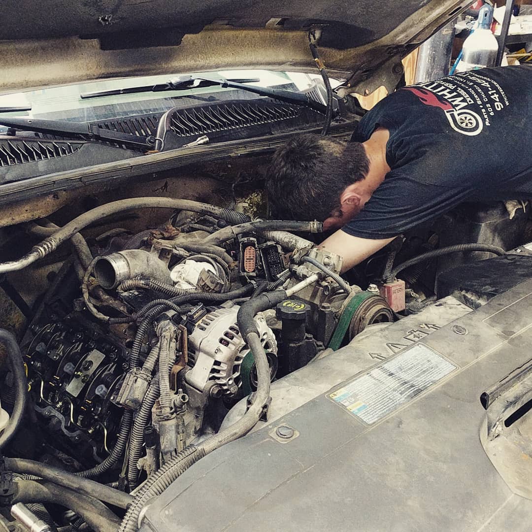 Employee repairing diesel truck